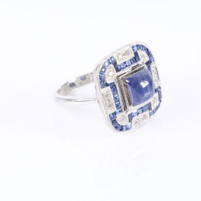 Platinum ring set with a cabochon sapphire...