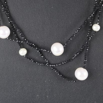 Three-strand necklace adorned with black...