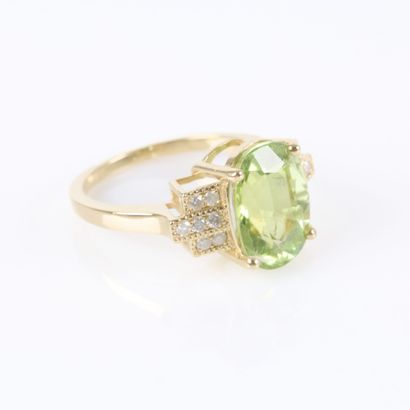 Gold ring set with an oval-cut green tourmaline...