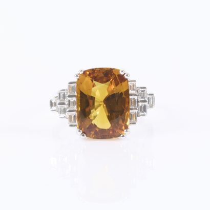 White gold ring set with a treated orange...