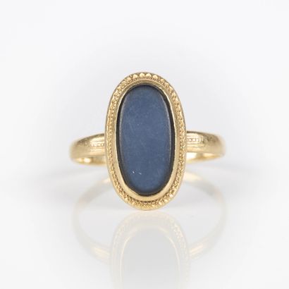 Gold ring set with an oval-shaped jet stone....