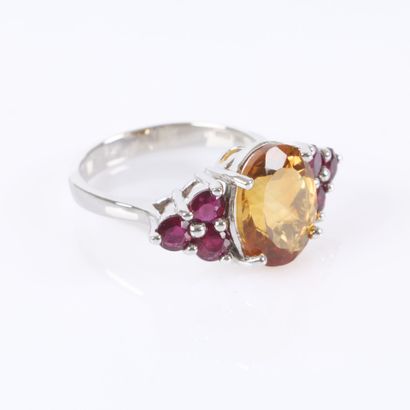 White gold ring set with an oval-cut citrine...