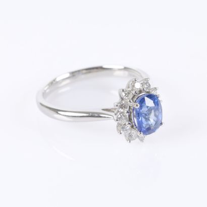 Platinum daisy ring set with an oval-cut...