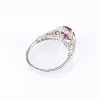White gold ring set with a round ruby surrounded...