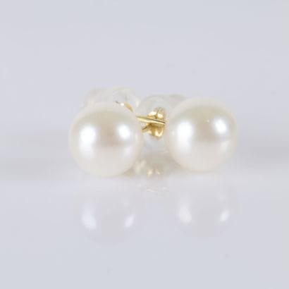 Pair of gold buttons, each adorned with an...