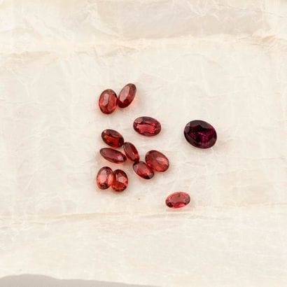 Small batch of faceted oval garnets.

Total...
