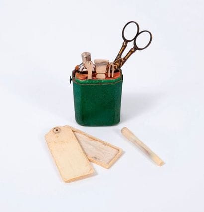 Travel kit in a wooden case covered with...