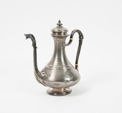 Coffee pot in the shape of a top on a silver...