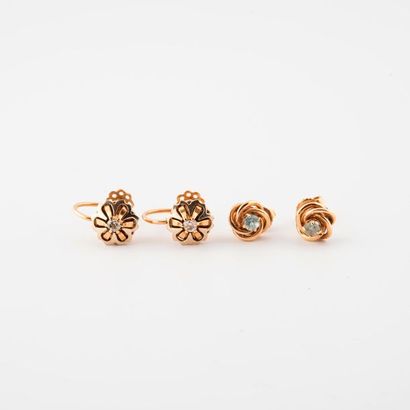 Two pairs of ear ornaments:

- a pair of...