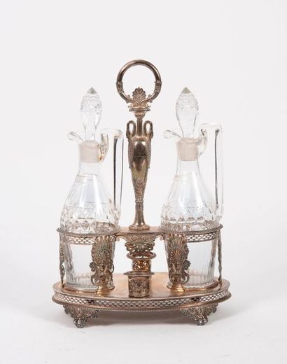 A silver oil and vinegar holder (950) with...
