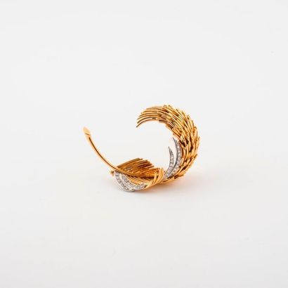 A yellow gold (750) lapel clip featuring...