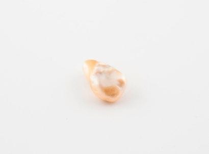 Fine white pearl of baroque shape, on paper....