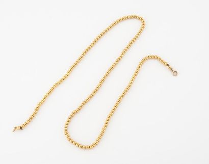 Yellow gold pearl necklace (585). 
 Handcuff...