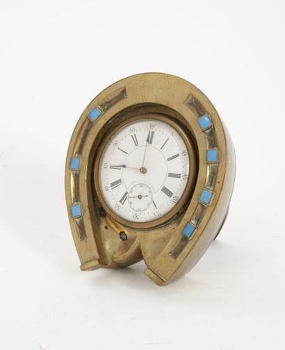 Brass desk clock, on an easel, in the shape...