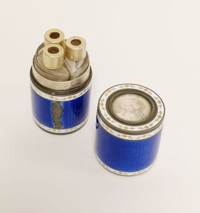 Cylindrical perfume set containing three...