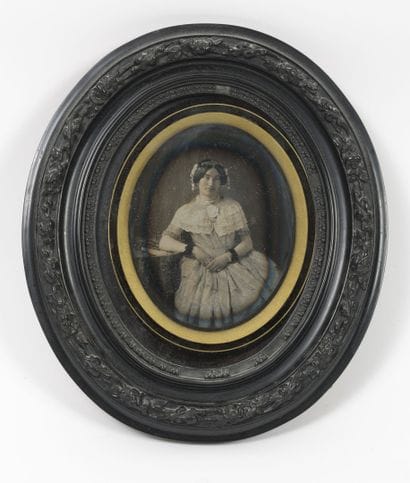 Portrait of a young woman leaning back, her...