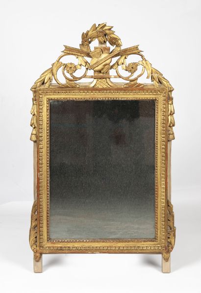 A giltwood pediment mirror carved with scrolls...