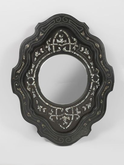 Witch mirror of circular shape with cartouche...