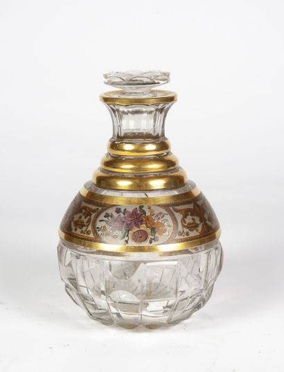 A colorless glass decanter with a neck and...