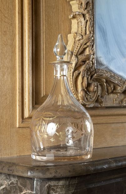 Wine bottle in colorless glass and gilded...