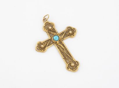 A yellow gold cross pendant with a turquoise...