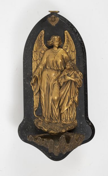 
A gilded and stamped metal stoup featuring...