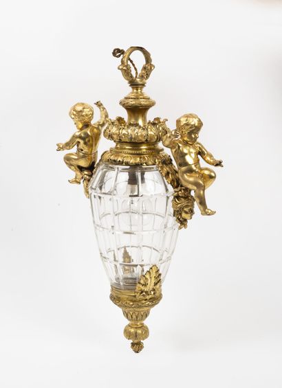 Glass and bronze lantern with two putti decorations.

53...