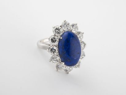 A white gold (750) ring centered on a cabochon...