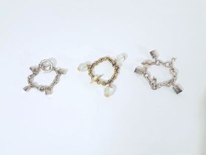 CARITA
Set of three metal bracelets with...