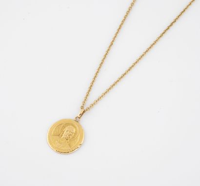 Religious medal in yellow gold (750) representing...
