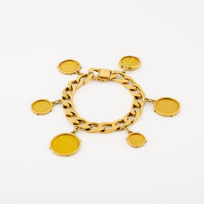 
Yellow gold (750) curb chain bracelet holding...
