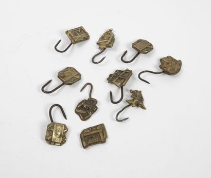 Set of ten patinated metal hooks with craft...