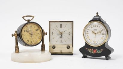 DEP
Metal and brass clock on a round white...