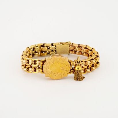 Bracelet articulé en or jaune (585) centré...
