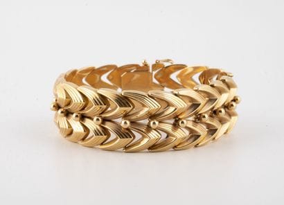 Bracelet ruban articulé en or jaune (750)...