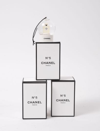 CHANEL
Box of three mini snow globes with...