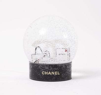 CHANEL
Snow globe with logo surrounded by...