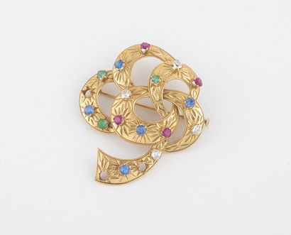 Broche en or jaune (750) en forme de boucles...