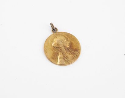 Religious medal in yellow gold (750) representing...