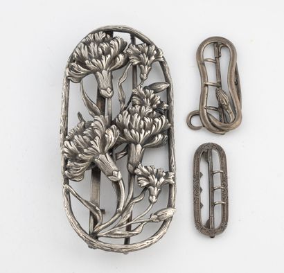 A small oval silver belt buckle (800) stamped...