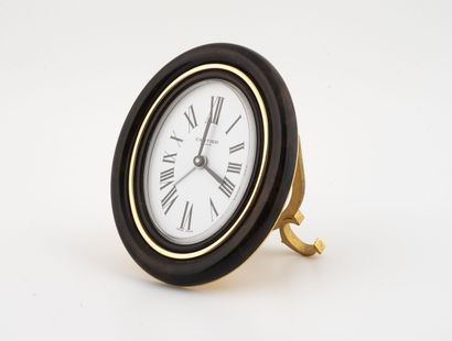 CARTIER, MUST
Oval alarm clock in gilt metal,...