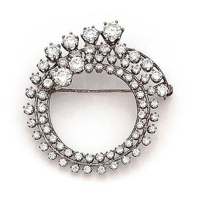 Broche circulaire en or gris (750 et 585)...
