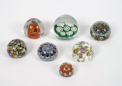Seven paperweight balls, some flattened,...