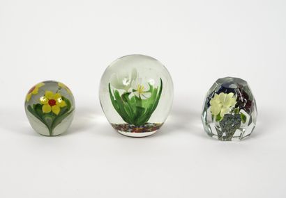 Three paperweights of ovoid form, one faceted,...