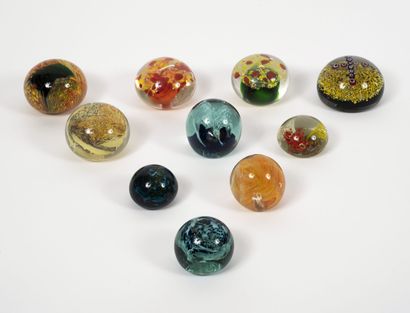 Ten paperweights in colorless or bluish glass...