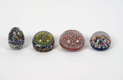 Four paperweights in colorless glass with...
