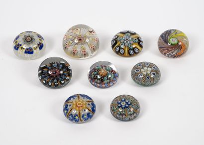 Nine paperweight balls, some flattened, in...