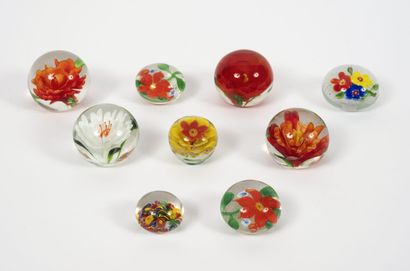 Nine small paperweights, some flattened,...