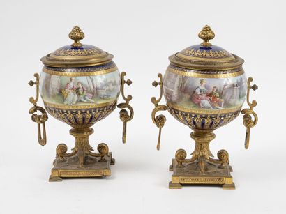 Pair of covered round-bodied vases, in polychrome...