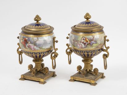Pair of covered round-bodied vases, in polychrome...